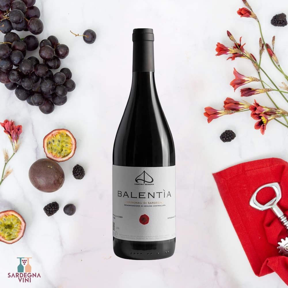 Bottle of Balentìa Cannonau di Sardegna 2023 Non Filtrato red wine by Cantina Dessena on a wooden table.