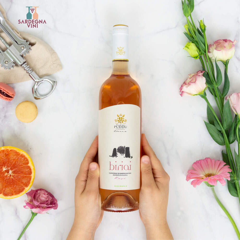 Biriai Cannonau Nepente Rosato 2023 wine bottle with a pink hue and elegant label, set against a neutral background.