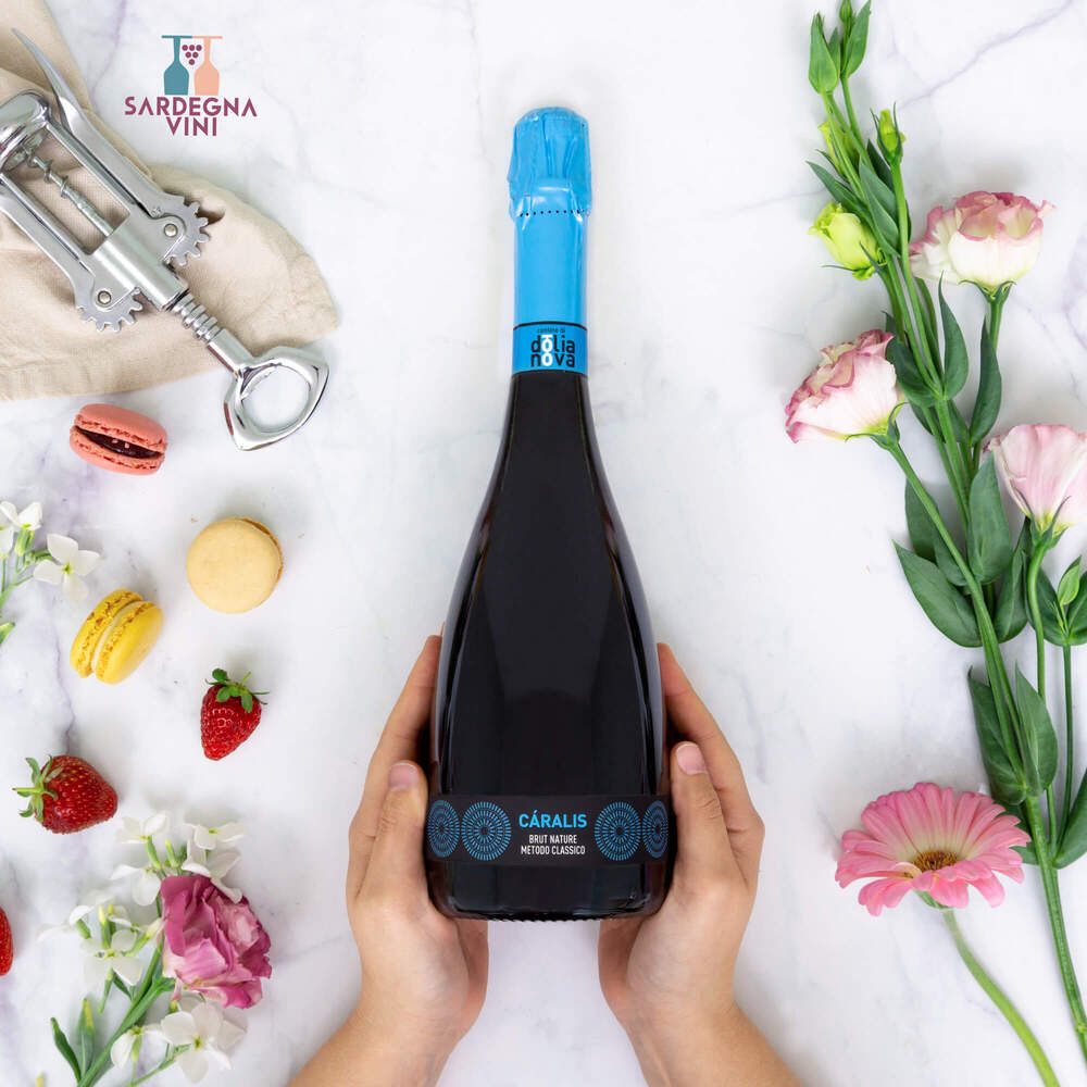 Caralis Brut Nature Metodo Classico 2019 sparkling wine bottle with elegant label and cork in a glass setting.