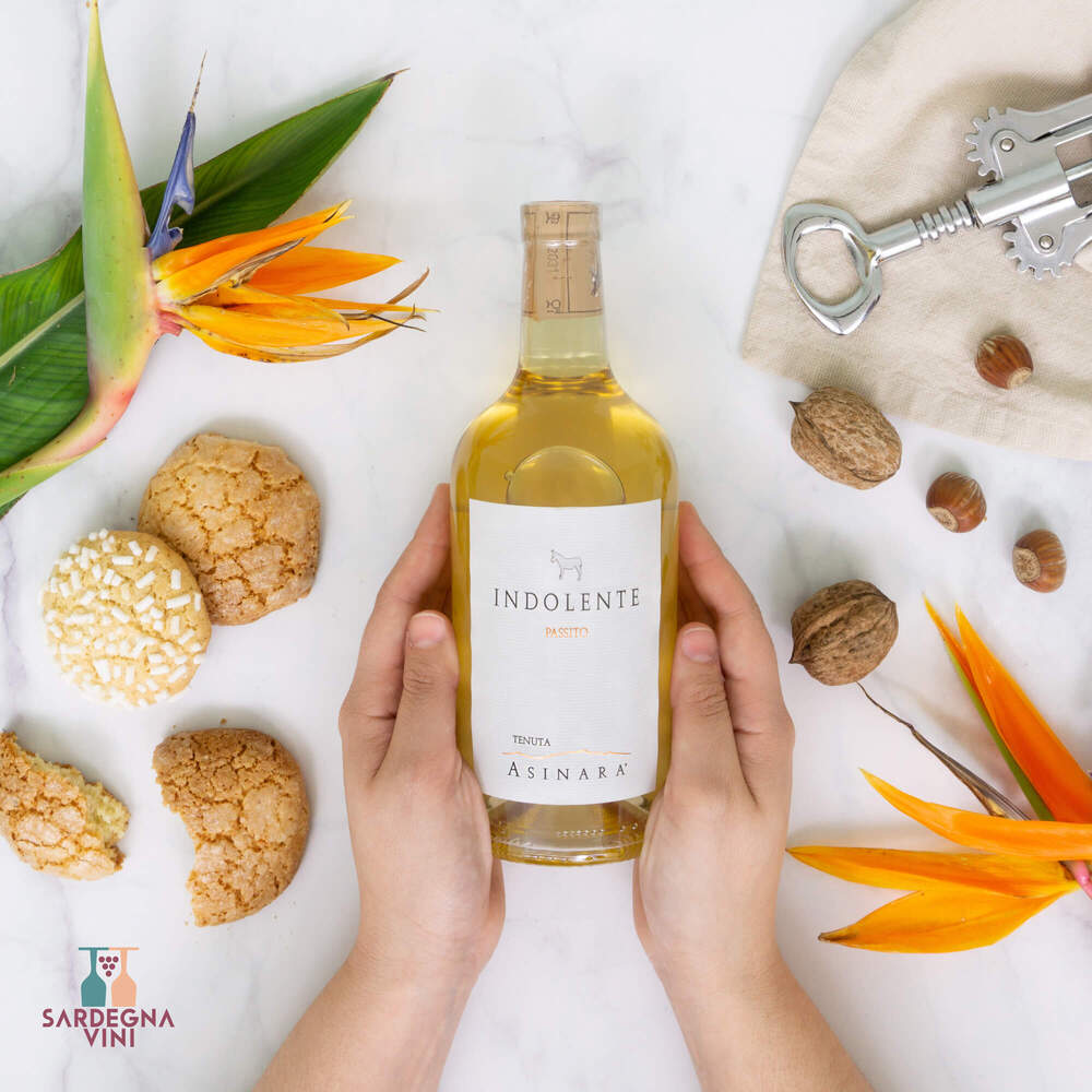 Indolente Passito Moscato di Sardegna 2019 wine bottle with elegant label and golden liquid, by Tenuta Asinara.