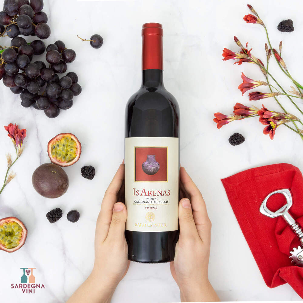 Is Arenas Carignano del Sulcis Riserva 2022 red wine bottle with a deep red hue and elegant label design by Sardus Pater.