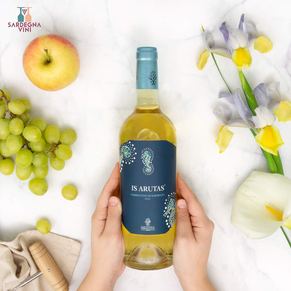 Is Arutas Vermentino di Sardegna 2024 bottle with white wine in a clear glass, showcasing its crisp color and label design.
