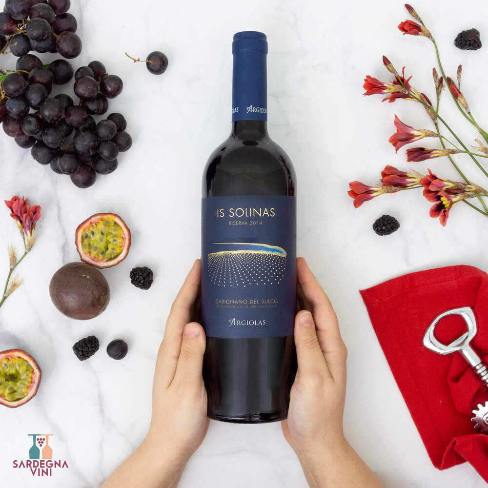 Is Solinas Carignano del Sulcis Riserva 2020 bottle showcasing rich red wine color and elegant label design by Cantina Argiolas.