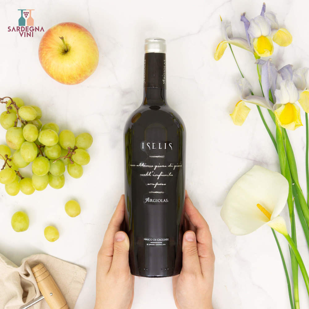 Iselis Nasco di Cagliari 2023 white wine bottle by Cantina Argiolas with elegant label design on a wooden table.
