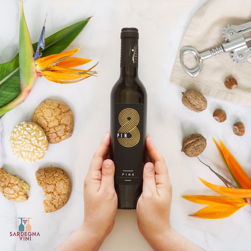 Bottle of Cantina Carboni Pin8 Aleatico Passito IGT, a sweet dessert wine with rich amber color and elegant label.